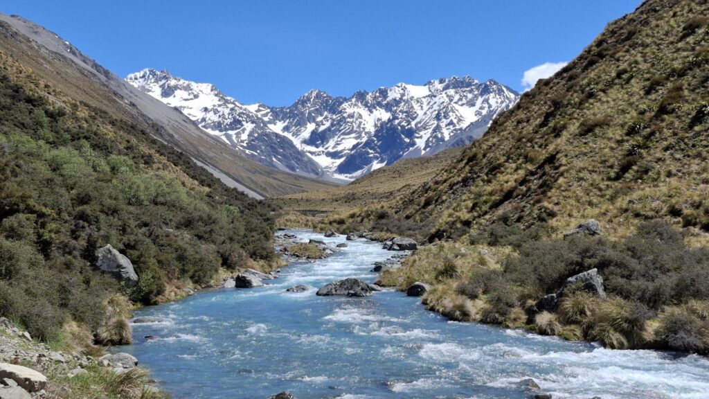 A river with a glacier in the background.