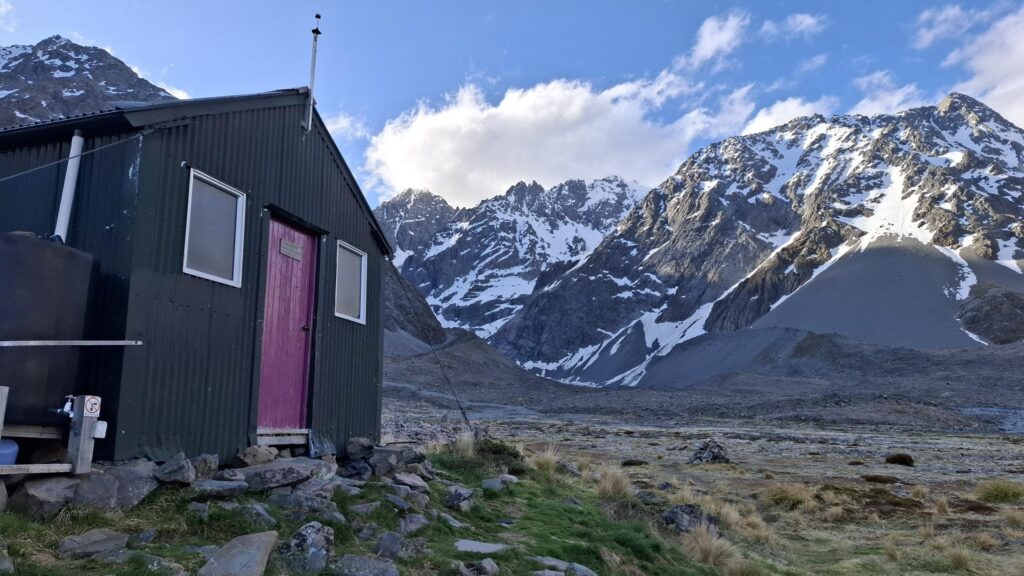 A mountain hut with purple door.