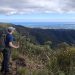 Man with backpack looking over the hinterland.