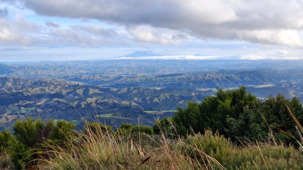 A volcanic mountain seen from another mountain range.